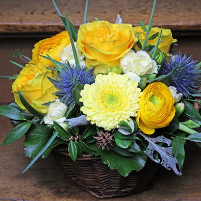 Yellow flower arrangement in a large basket